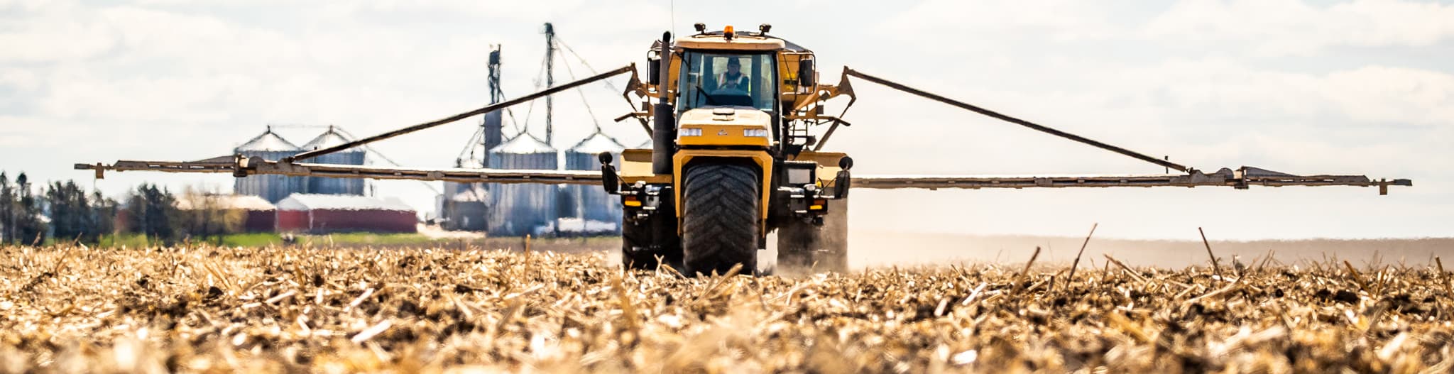 Tractor driving through harvested field